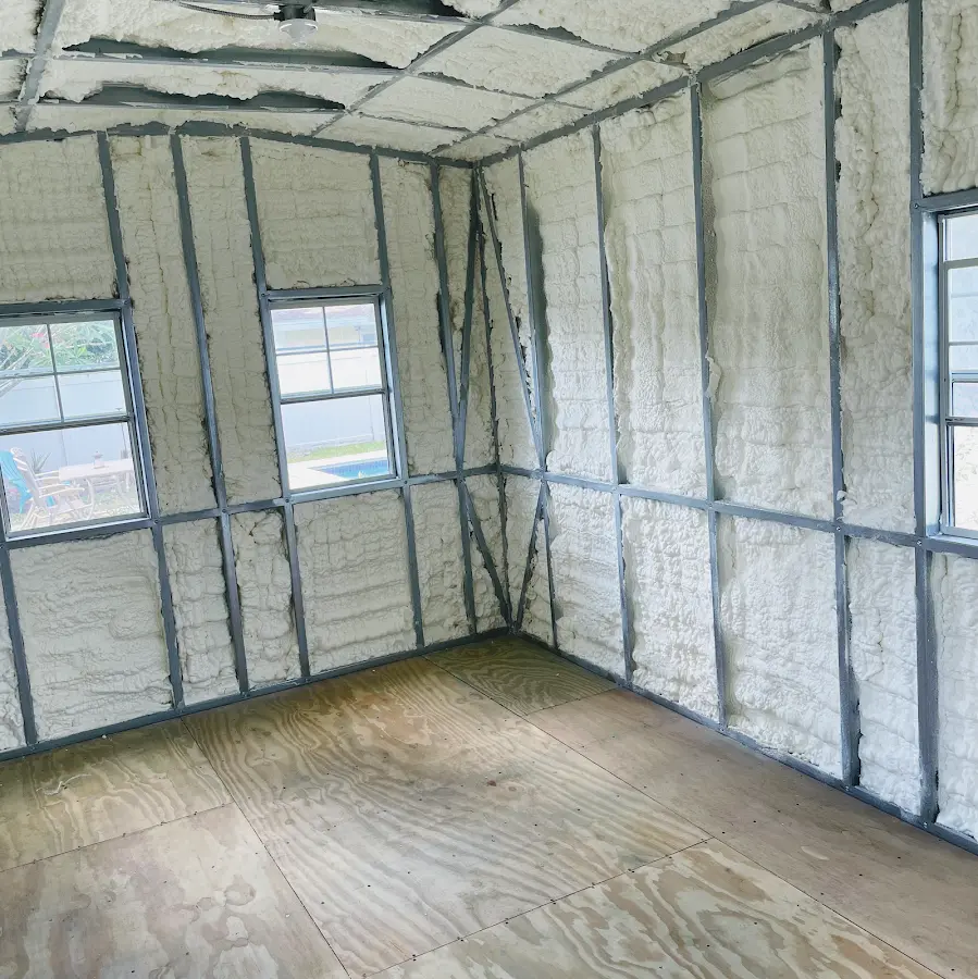Closed-cell spray foam insulation applied to wall cavities in a residential project in Fairport